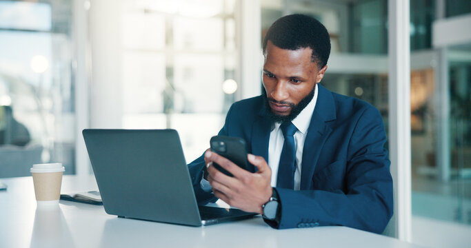 Business, man and laptop with phone in office for record keeping, finance app and auditing. Accountant, black person or tech at desk for financial reporting, budget review or MFA code to track income