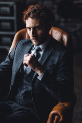 Portrait of strong healthy elegant handsome sexy athletic red hair bearded man in suit and white shirt in a stylish loft interior. Male model posing and smiling, casual clothing
