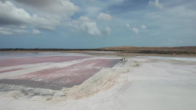 Drone view of vast salt flats under blue sky near Araya and Salinas