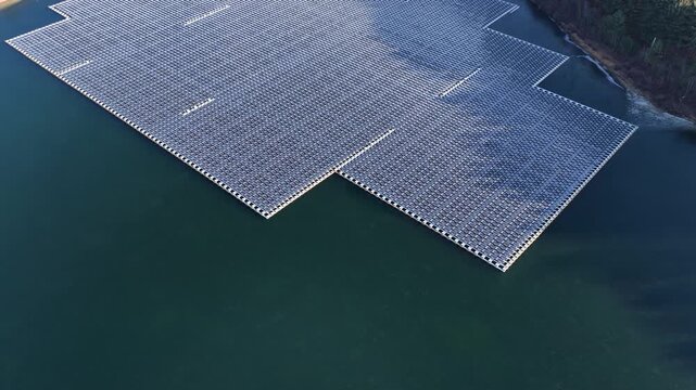 Flying over a large floating solar panel array on a reservoir in Sayreville, New Jersey