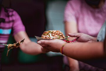 The hands of the hungry are asking for food from the donor