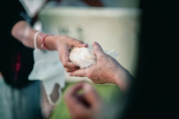 Volunteers are giving food to the homeless poor, Free distribution of food to the poor in today's society