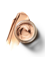 Luxurious creamy beige foundation makeup swatch displayed in an open glass jar