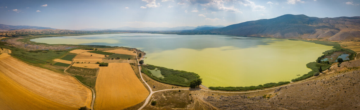 Lake Petron in ,Macedonia, Greece. The wide panoramic view of the green lake is showing a dry vegetation