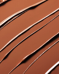 Abstract macro shot of rich, glossy, medium brown cosmetic foundation texture swatches.