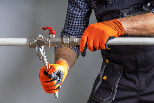 Plumber working with wrench. Plumbing work.