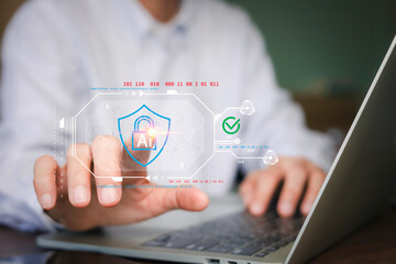 Businessman using laptop with virtual AI shield and padlock icon for cyber security. Concept of artificial intelligence data protection, private network safety, and cloud firewall encryption.