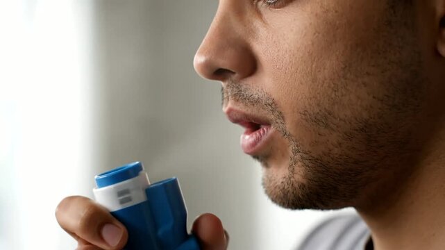 Man Using Asthma Inhaler Closeup.