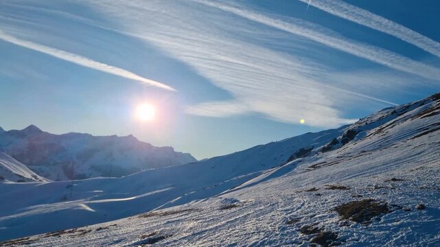 Passenger view from a moving ski chairlift in the Adelboden&ndash;Lenk region of Switzerland on a crisp, sunny winter day, showcasing clear skies and alpine scenery
