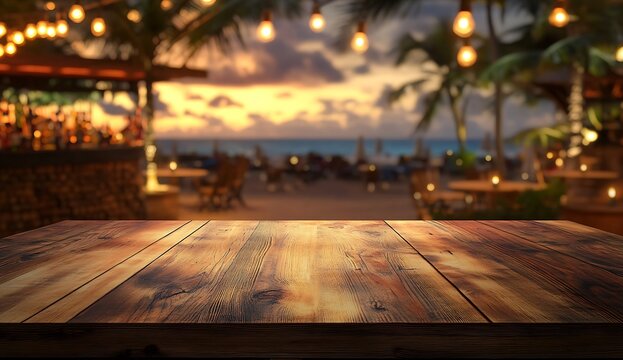 Rustic wooden table surface foreground with blurred tropical beach bar at sunset wood texture empty table