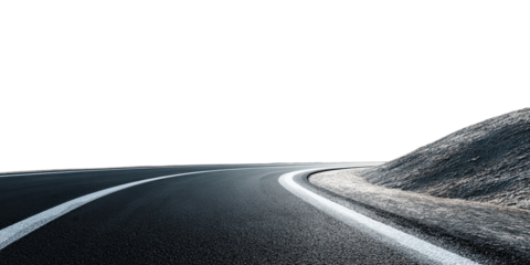 Asphalt road curves into darkness with a textured embankment on the right