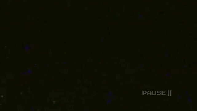 Paused and grainy dark video cassette recording, suitable for retrothemed projects or adding a vintage aesthetic to videos.