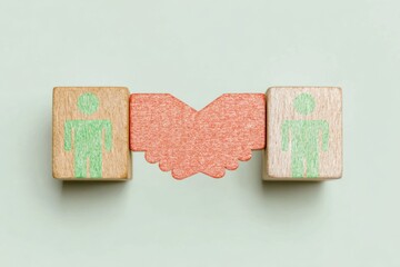 Wooden cube blocks with handshake icon connecting professional figures, representing a business ecosystem, successful partnership deal and collaboration with copy space