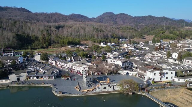 Xidi, China: Aerial drone footage of the famous Xidi ancient village with its famous paifang, a memorial archway, in the countryside near Huangshan in Anhui province in China. 