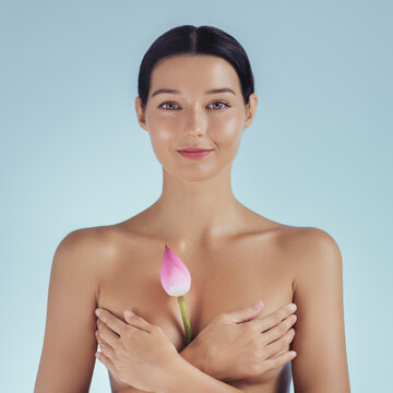 Serene Woman Holding Pink Lotus Bud for Natural Beauty and Wellness Concept