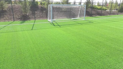 Penalty area in front of the football goal. The part of the field where the goalkeeper can pick up the ball. Soccer field goal. High quality 4k footage