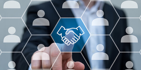 Businessman's finger pointing to a blue hexagonal handshake icon, representing successful business collaboration and agreement.