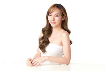 A beautiful young Asian woman with clean, fresh skin against a white background. Skincare, facial treatment, cosmetology, beauty, and spa. An elegant portrait of an Asian woman.