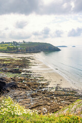 View at a sand beach in a rocky coastline in Bretagne
