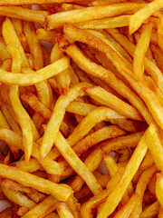 fried potatoes with salt on the background