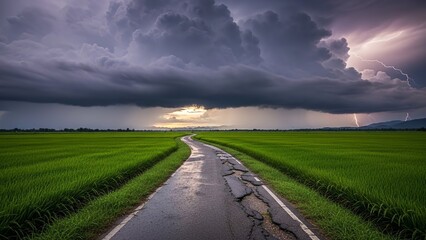 A cracked road leads through a lush green field under a stormy sky with lightning