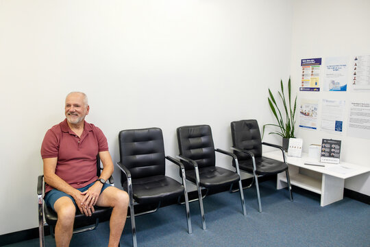 Senior man sitting patiently on chair in the waiting area
