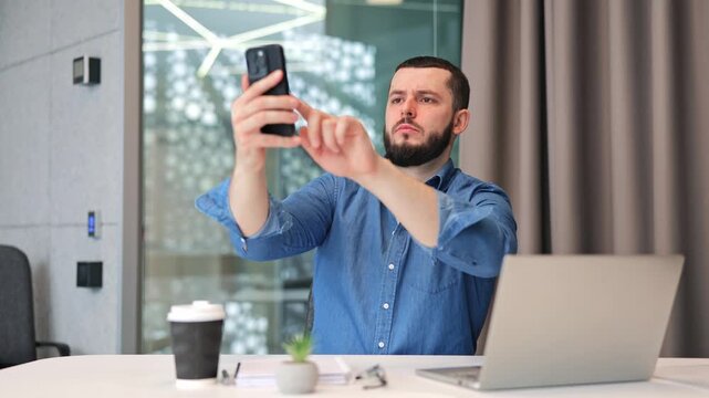 Businessman in office experiences disappointment while trying to locate mobile network signal on smartphone. Connectivity issues cause frustration, hindering work.