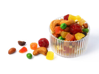 Mix dried fruit and nuts in a clear bowl isolated on white background.
