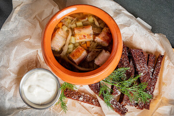 Hearty stew with veggies and tender meat, served with crusty bread and sauce