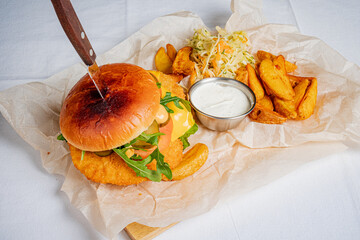 Crispy fried chicken burger, fresh toppings, golden wedges, and tangy coleslaw