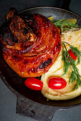 A stunning dish with tender roasted meat, creamy mashed potatoes, and fresh tomatoes