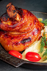 Tender roasted meat glistens with marinade, served with creamy mashed potatoes and colorful veggies