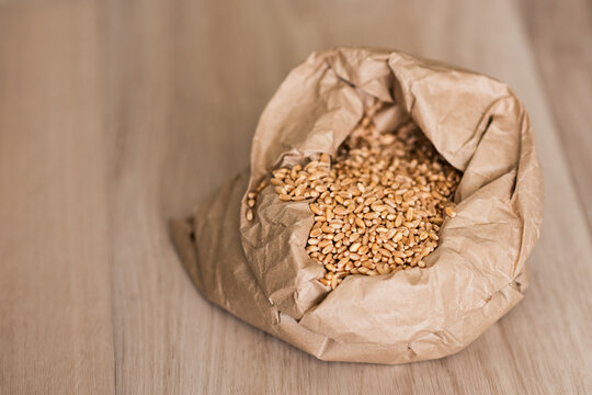 A paper sack contains whole wheat grains