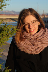 Portrait of a beautiful woman outdoors on a winter day in the sunny morning