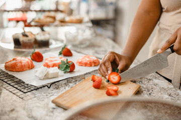 Beautiful Multiracial Woman Chopping Strawberries
