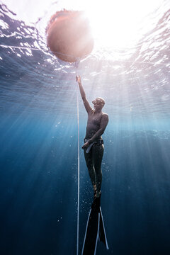 Freedive Athlete Following Rope to Surface