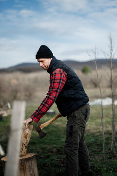 Man chopping wood in a rural area