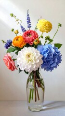 Colorful floral arrangement in a clear glass vase against a plain backdrop, bathed in soft, natural light