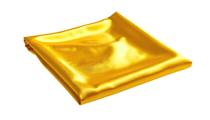Folded square of luminous, golden fabric isolated against a stark black background