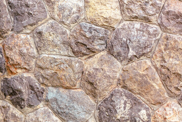 A wall made of stone with a brownish color