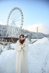 Girl in a white fur coat, winter portrait with snowy background, cozy and stylish cold season fashion look.