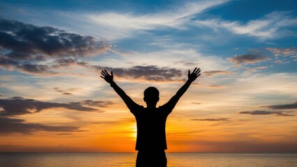 Fototapeta premium Silhouette of person celebrating sunset
