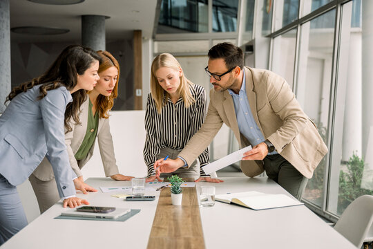 Business team discussing project at a table in a modern office
