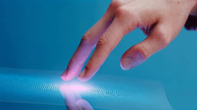 Human finger touching a glowing digital surface creating a futuristic interaction scene symbolizing technology innovation connectivity and intuitive interface design