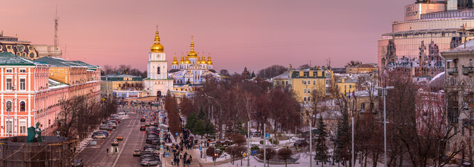View of Kyiv after sunset, pink winter sky glowing above the city 