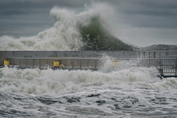 STORM AT SEA - Powerful waves of foaming sea water at the pier