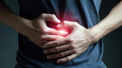 Person Pressing Hands on Abdomen with Glowing Highlight for Pain Relief
