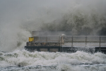 STORM AT SEA - Powerful waves of foaming sea water at the pier