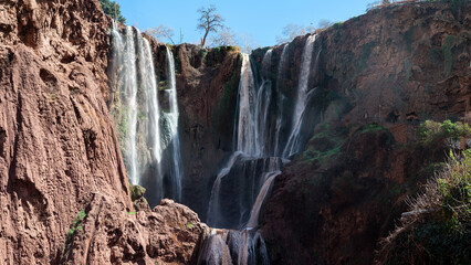 Majestic Ouzoud waterfalls cascade through cliffs in Morocco on a sunny day