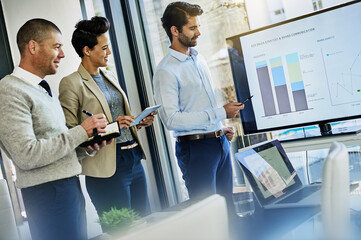Business people, meeting or presentation with team or screen for analytics or statistics in office. Group, employee or colleagues with display, graph or chart for performance review or company growth
